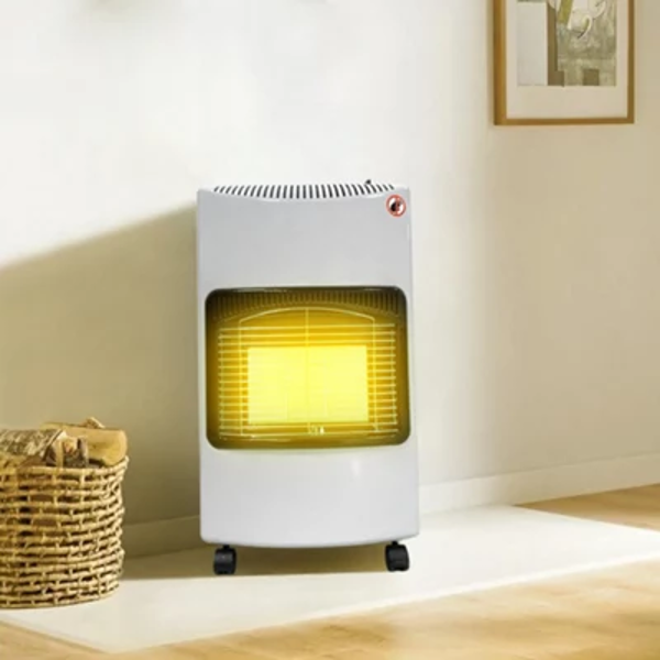 Portable gas heater with a glowing yellow heat panel standing on the floor in a room
